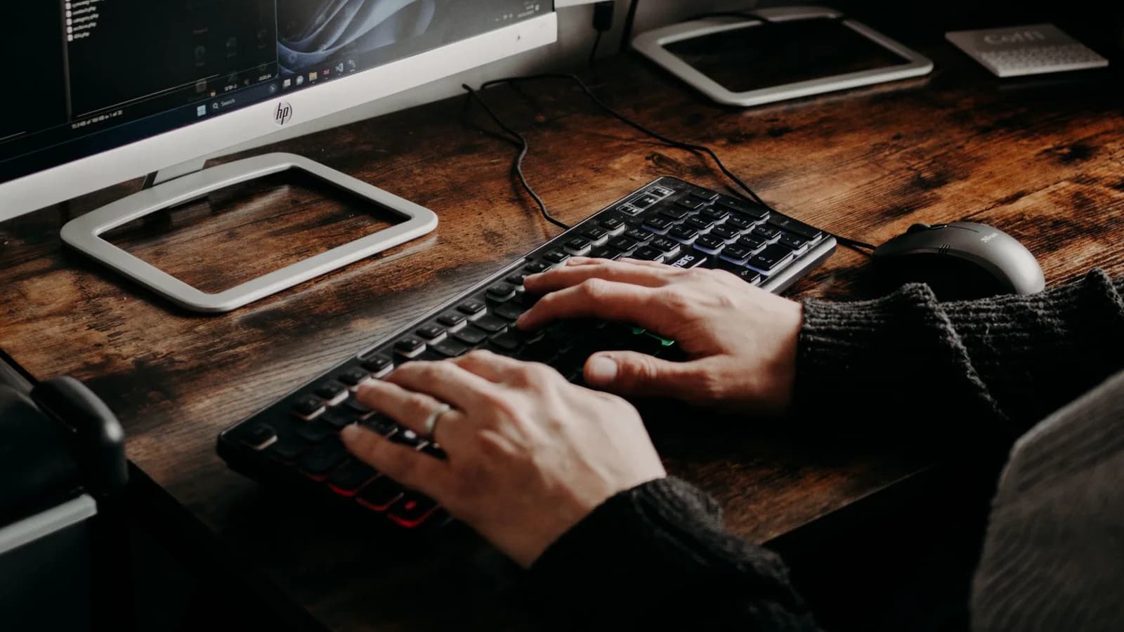 A web professional developing a website across a desktop workstation