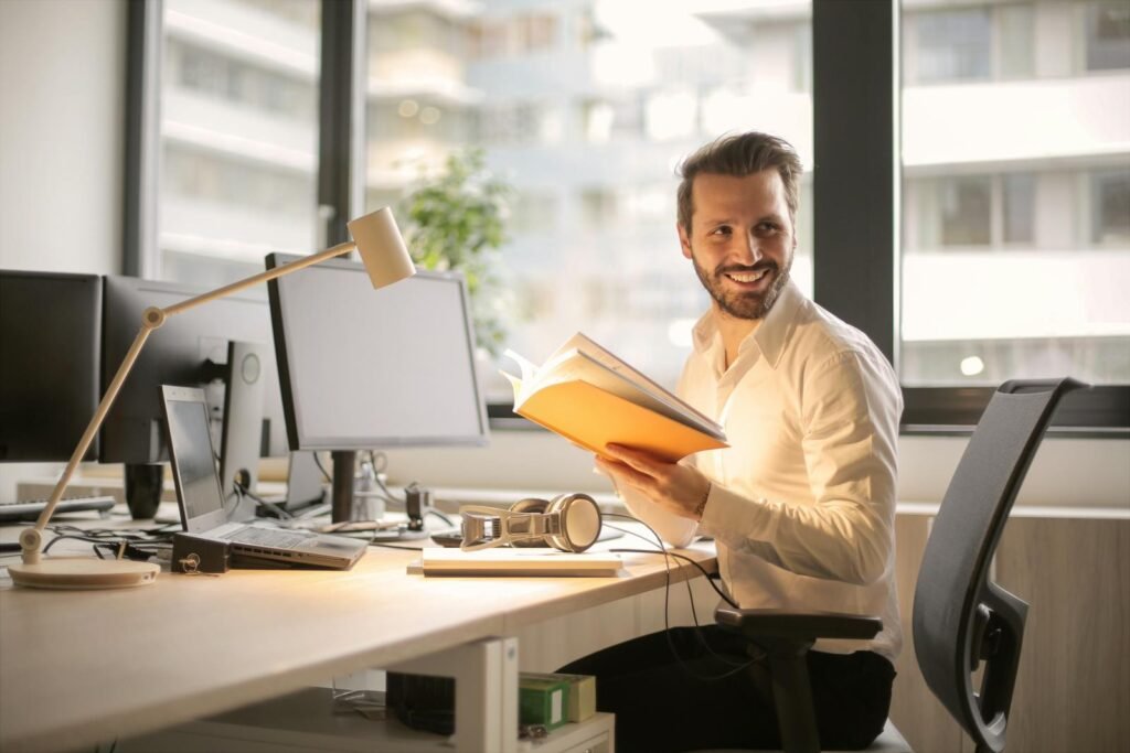 What does digital marketer do? 10 Photo of Man Holding a Book